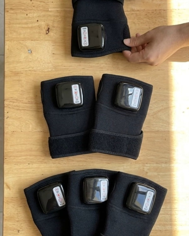 Real photo: one, two or three heated knee wraps laid out on a table